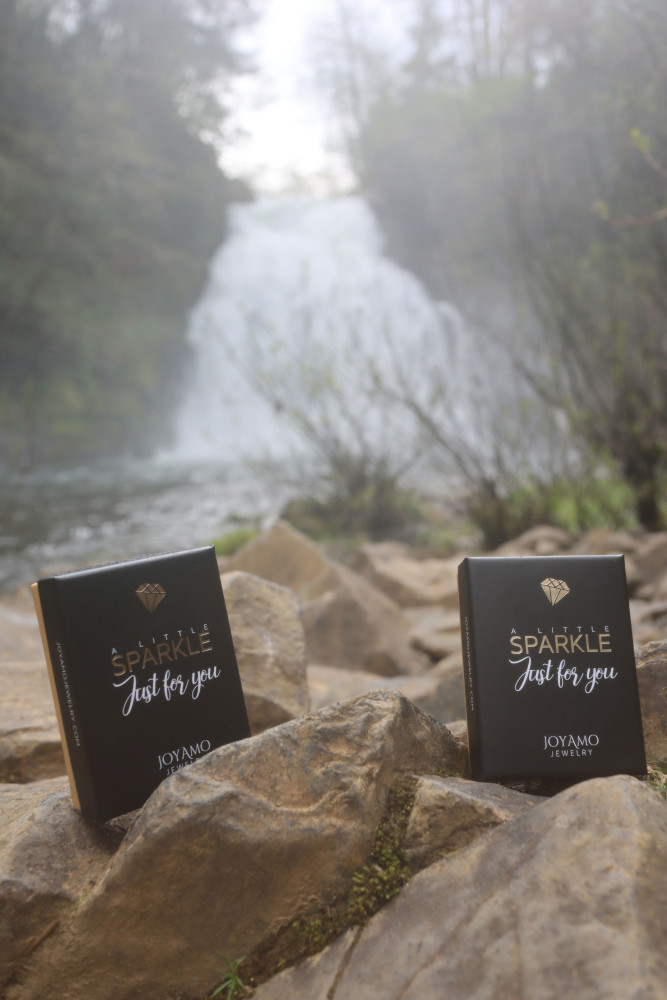 JoyAmo boxes by a waterfall